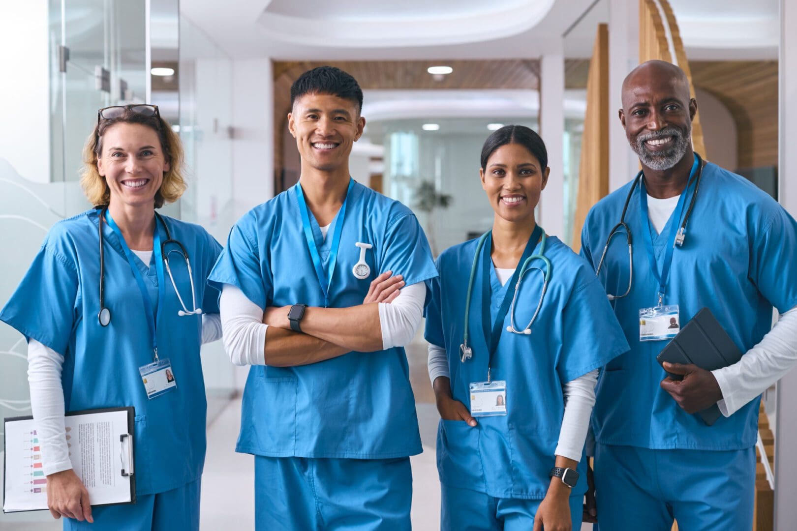 Group of smiling healthcare professionals in scrubs.